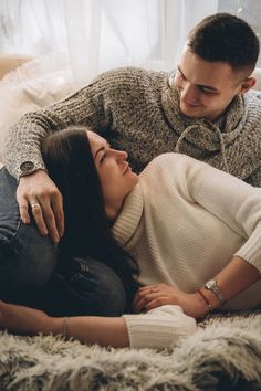 a man and woman laying on the floor together