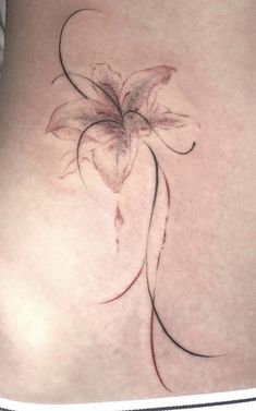 a woman's stomach with a flower tattoo on it