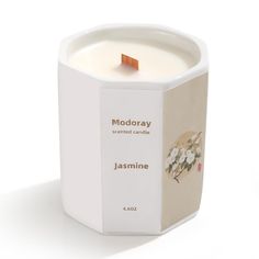 a candle that is inside of a box on a white surface with the words, modoray scented candle, jasmine