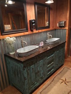 a bathroom with two sinks and mirrors on the wall