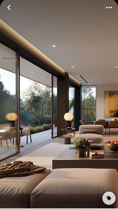 a living room filled with lots of furniture and large glass doors leading to an outside patio