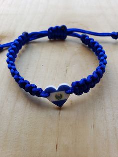 a blue and white bracelet with a heart on it