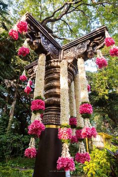 an elaborately decorated pole with flowers on it