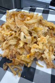 a pile of fried food sitting on top of a checkered tablecloth covered plate