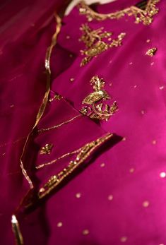 Indulge in " Magenta Jewel " rendered in pure raw silk 80 gms with delicate zardosi work in gold+antique paired with ( pure ) chiffon dupatta and raw silk trousers with handwork. No matter the event, this ethereal look is sure to turn heads.   Delivery Time:  4 to 6 weeks Diwali Tissue Silk Sharara With Gota Work, Eid Traditional Wear With Gota Work On Tissue Silk, Festive Tissue Silk Sharara With Gota Work, Traditional Drape Sharara With Dori Work, Silk Churidar With Sheer Dupatta For Navratri, Festive Raw Silk Sharara With Gota Work, Navratri Chanderi Churidar With Gold Embroidery, Traditional Silk Anarkali Set With Gota Work, Festive Gota Work Sharara In Raw Silk