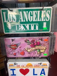 three license plates are stacked on top of each other in the shape of heart and i love los angeles