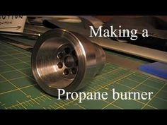 the words making a propane burner are in front of a cutting board with scissors