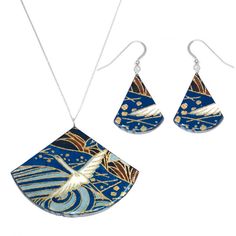 two pieces of jewelry with blue and gold designs on them, one is shaped like a bird