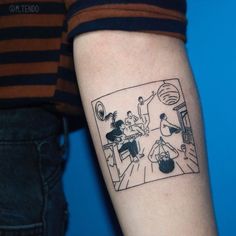 a person with a tattoo on their arm that has a cartoon scene drawn on it