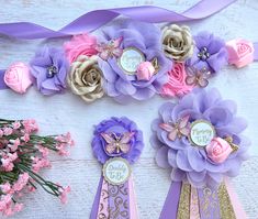 purple and pink flowers are arranged on top of each other, along with ribbons that say happy birthday