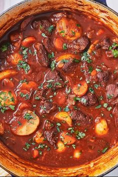 a pot full of stew with meat and vegetables