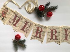 a merry banner with ornaments and ribbon hanging from it's sides on a table