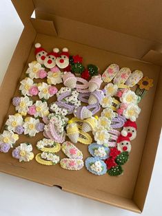 an open box filled with crocheted flowers