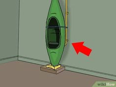 a green kayak sitting in the corner of a room with an arrow pointing to it