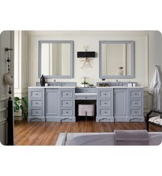 a large bathroom with two sinks and mirrors on the wall next to a bathtub