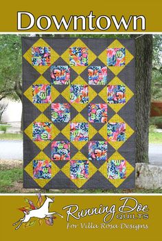 the cover of down town quilt book, featuring an image of a yellow and black quilt