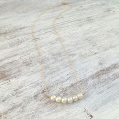 Gold necklace with white freshwater pearls in a row attached to a 14k gold filled delicate chain.A beautiful, dainty and delicate necklace. 14k gold filled / sterling silver chain. All my jewelry are packed in an elegant gift box.If you want to give it as a gift you can specify the address and I'll be happy to send it on your behalf. Wedding Necklace Pearl, Gold Bridesmaid Necklace, Pearl Necklace Long, Long Pearl Necklace, Gold Necklace Wedding, Pearl Necklace Gold, Bridal Pearl Necklace, Pearl Bridal Jewelry, Pearl Necklace Wedding