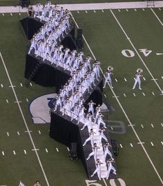 an aerial view of a football field with marching band