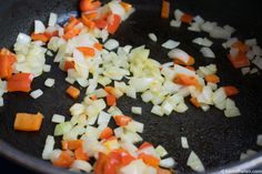 chopped carrots and onions cooking in a skillet