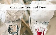 two toilets covered in white paint with the words creamest textured paste over them