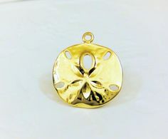 This vermeil sand dollar charm measures about 18mm in diameter. It is perfect for bracelet, necklace and earrings. It is 18k gold plated over 925 sterling silver (vermeil), shiny  gold.925 stamped in the back.1 pc.silver version: Listing: http://www.etsy.com/listing/114478741/925-sterling-silver-oxidized-sand-dollarmatte vermeil version: Listing: http://www.etsy.com/listing/150706144/vermeil18k-gold-over-925-sterling-silverFor the larger quantity convo us.Thanks for stopping by! Yellow Gold Pendant Jewelry For The Beach, Gold Pendant Jewelry With Starfish Charm, Tarnish Resistant Gold Jewelry For Beach, Tarnish Resistant Gold Beach Jewelry, Gold Round Jewelry For The Beach, Gold Pendant Jewelry For Beach, Gold Round Jewelry For Beach, Gold Round Pendant Jewelry For The Beach, Gold Round Beach Jewelry