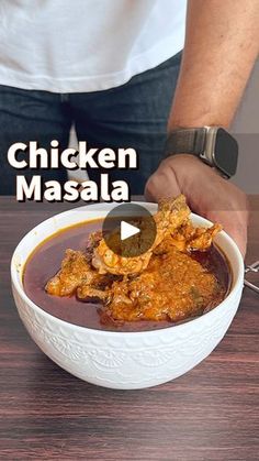 chicken masala in a white bowl being held by a man's hands with the words chicken masala above it