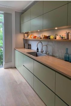 a kitchen with wooden counter tops next to a sliding glass door