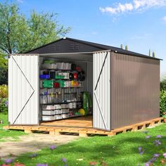 a storage shed with its doors open on the grass and purple flowers in the background