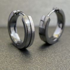 Men's large hoop earrings made from sterling silver. The men's hoops are plated in black gold to give it a charcoal finish. The discrete line down the center adds a distinctive masculine design element. Other color variations and earring pouches are available in our store. SPECIFICATION Base metal: Recyclable fine 925 Sterling Silver Outer layer: Shiny black gold, thick coating Outer Diameter: 15 mm, Large hoop size Inner Diameter: 12mm shop policy http://www.etsy.com/shop_policy.php? Learn more Small Metal Hoop Earrings, Hypoallergenic Metal Hoop Earrings, Man Lifestyle, Boyfriend Things, Mens Earrings, Men's Earrings, Earring Styles, Black Hoops Earrings, Mens Earrings Hoop