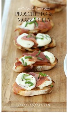 several appetizers are arranged on bread with cheese and herbs in the foreground