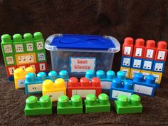 a plastic container filled with lots of different colored legos next to a set of matching blocks