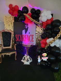 a stage set up with balloons, chairs and signs for scarface the musical at an event