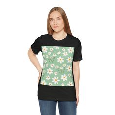 Made with soft cotton, this shirt features a charming daisy flower pattern on a refreshing spring mint green background. Embrace the joys of spring in style and comfort. This classic unisex jersey short sleeve tee fits like a well-loved favorite. These soft cotton t-shirts have-ribbed knit collars to bolster shaping. The shoulders are tapered for a better fit over time. Dual side seams hold the garment's shape for longer. .: Made with 100% Airlume combed and ring-spun cotton, a lightweight fabri Green Casual T-shirt For Spring, Casual T-shirt With Daisy Print For Spring, Light Green Short Sleeve Tops For Spring, Summer Green Daisy Print Top, Green Daisy Print Summer Top, Green Daisy Print Top For Summer, Casual Green Daisy Print Top, Spring Daisy Print Graphic Tee, Summer Daisy Print Short Sleeve T-shirt