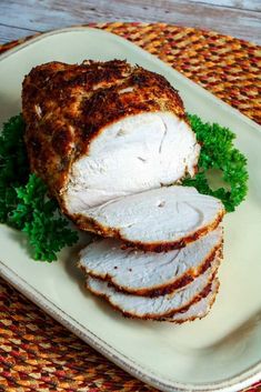 sliced turkey on a plate with parsley