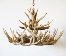 a chandelier with antlers hanging from it's sides and two lights on each side