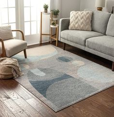 a living room with a couch, chair and rug