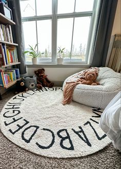 a child's bedroom with a large rug that says welcome home on the floor