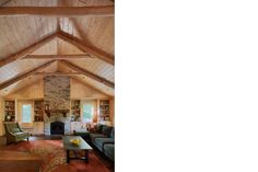 a living room filled with furniture and a fire place in the middle of a room