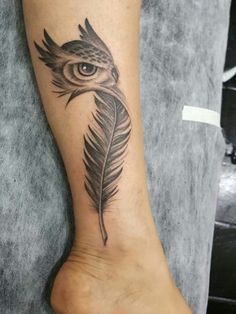 an owl with a feather tattoo on its foot