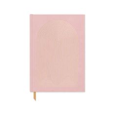 a pink notebook with a spiral design on the cover and a gold pencil sticking out of it