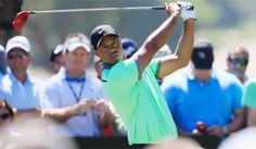 tiger woods hits his tee shot on the first hole at the players'championship golf tournament