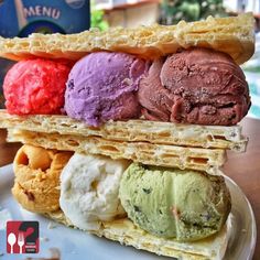 an ice cream sandwich is stacked high on a plate with three scoops in each