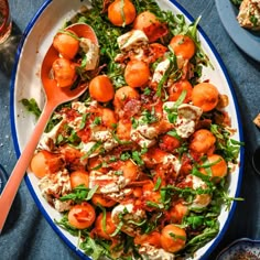 a plate full of salad with tomatoes and cheese