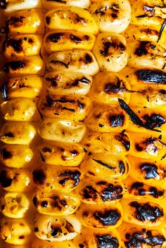 grilled hot dogs with mustard and black pepper on the grill, ready to be eaten