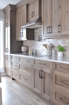 a kitchen with wooden cabinets and white marble counter tops