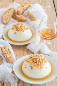 three desserts on white plates with wine and bread in the backgroung