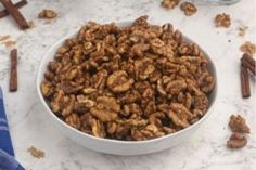 a white bowl filled with nuts on top of a table