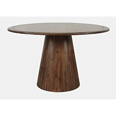 a round wooden table sitting on top of a white floor