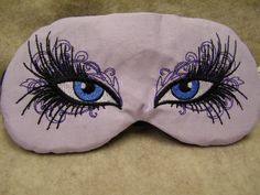 "Intense blue eyes with black, lush lashes embroidered on very pale lavender cotton fabric,  Black non-adjustable strap. black cotton flannel back. Packaged in cello bag.   This is a premade, ready to ship eye mask.  If you would like to customize (adjustable strap, fabric change, etc.) please see this listing:  https://www.etsy.com/listing/224650632/embroidered-eye-mask-sleep-sleeping-cute?ref=shop_home_active_80&crt=1 Order as shown and described - Elastic strap keeps it secure (adjustable strap also available) - Mask is approx. 6.5\" across, approx. 3\" tall (Mask fits 20-22\" head) - Strap is approx. 13.5\"  - Order with or without lavender (USA only) - Light blocking fabric panel and 4 layers of batting - Pillow softness - Perfect for kids (age 5+ recommended) and adults - Machine was Lavender Cotton, Eye Mask Sleep, Guys Night, Tissue Case, Pale Lavender, Fabric Panel, Fabric Black, Eye Design, Slumber Parties