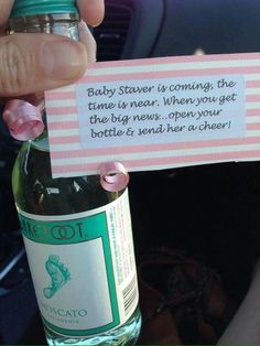 a person holding up a bottle with a label on it that says baby shower is coming the time is near when you get the bottle is next